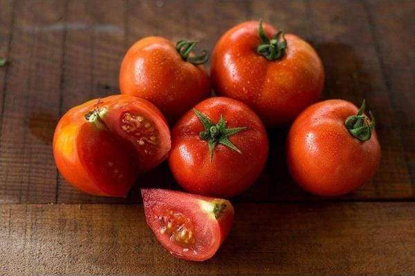 tomatoes on a wooden counter top