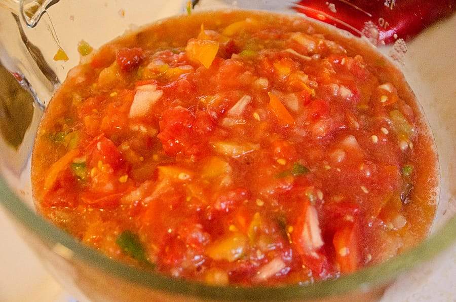 Pureed homemade salsa in a glass bowl.