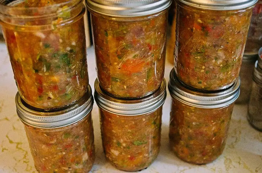 Homemade canned salsa in stacked Ball Jars.