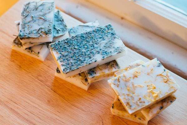 Three stacks of homemade, herbal garden soaps.